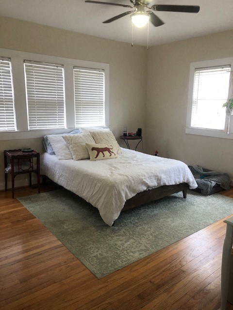 a bedroom with a bed and a ceiling fan