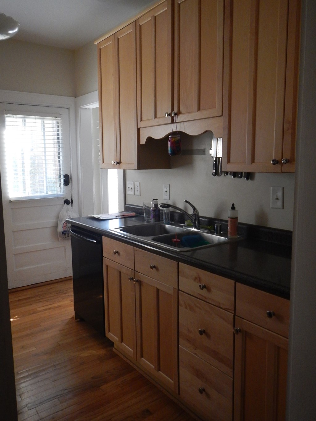 a kitchen with a sink and wooden cabinets