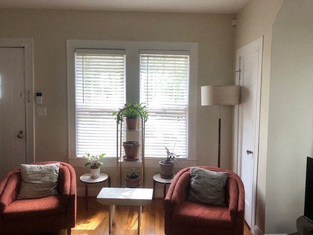 a living room with two red chairs and a table
