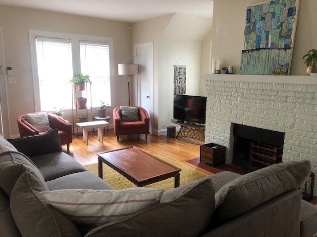 a living room with a couch and a fireplace