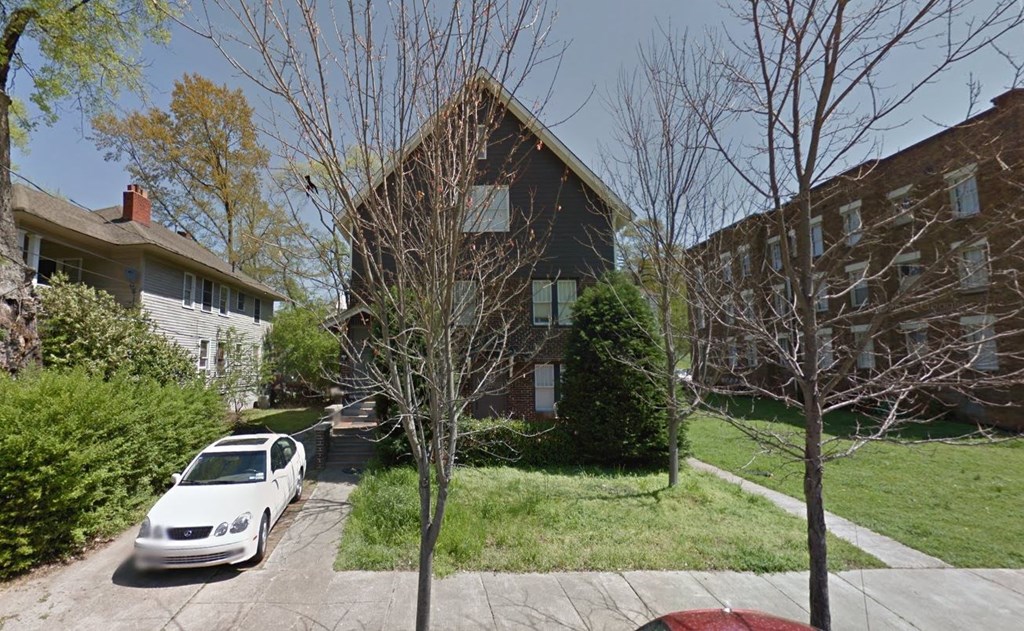 a house with a white car parked in front of it