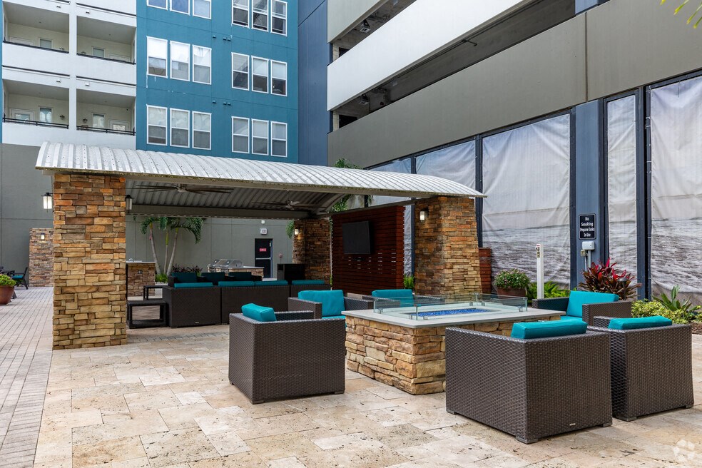 an outdoor patio with a pool and a building