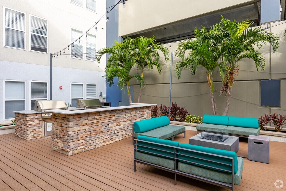 a patio with couches and a fire pit on a