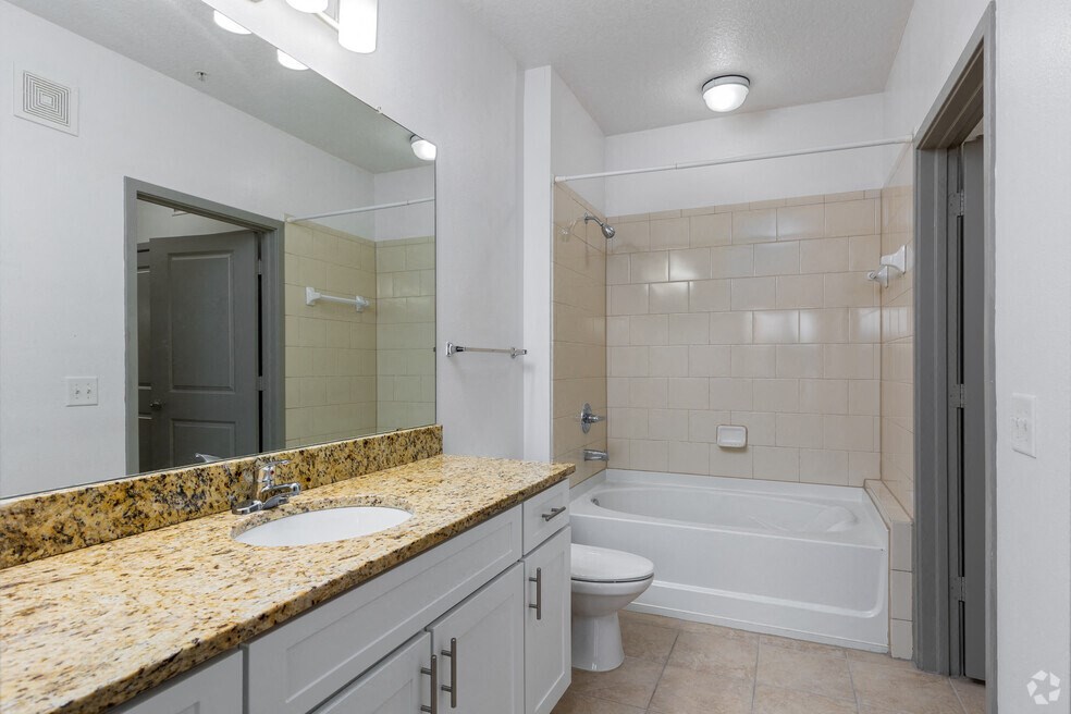 a bathroom with a sink and a toilet and a bath tub