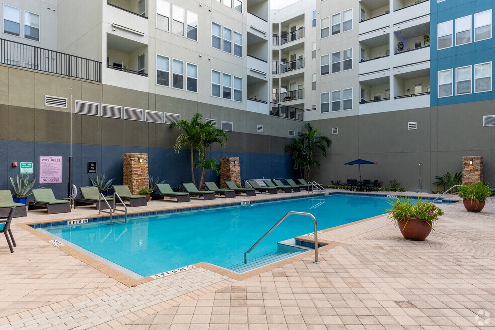 a swimming pool in front of an apartment building
