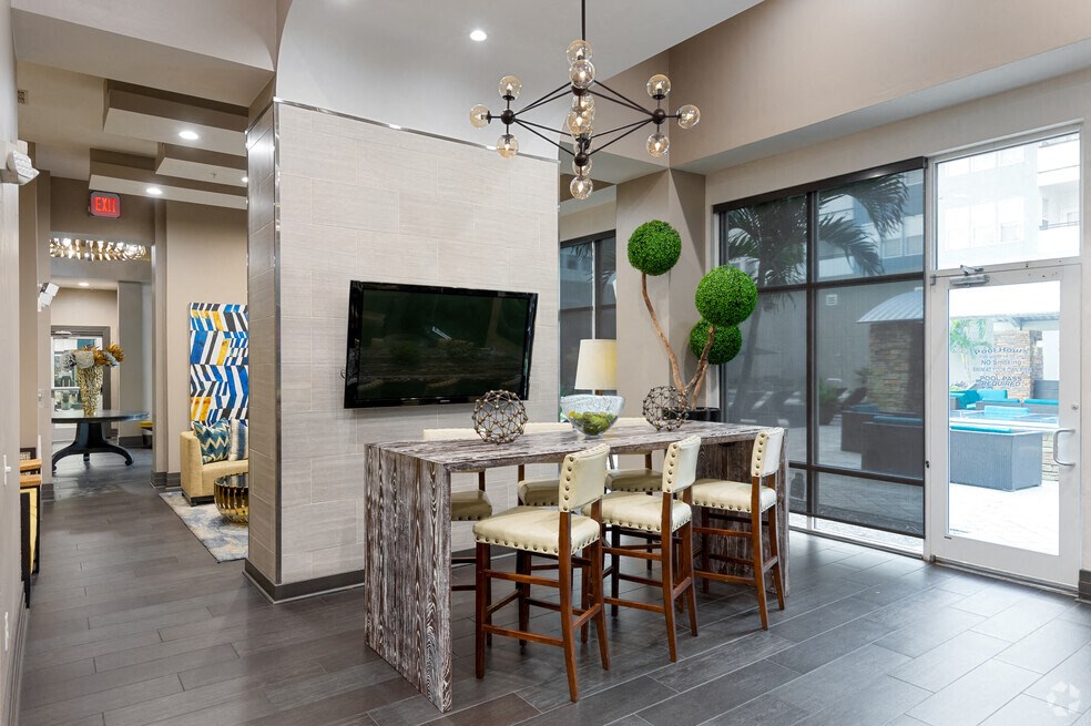a living room with a tv and a table with chairs
