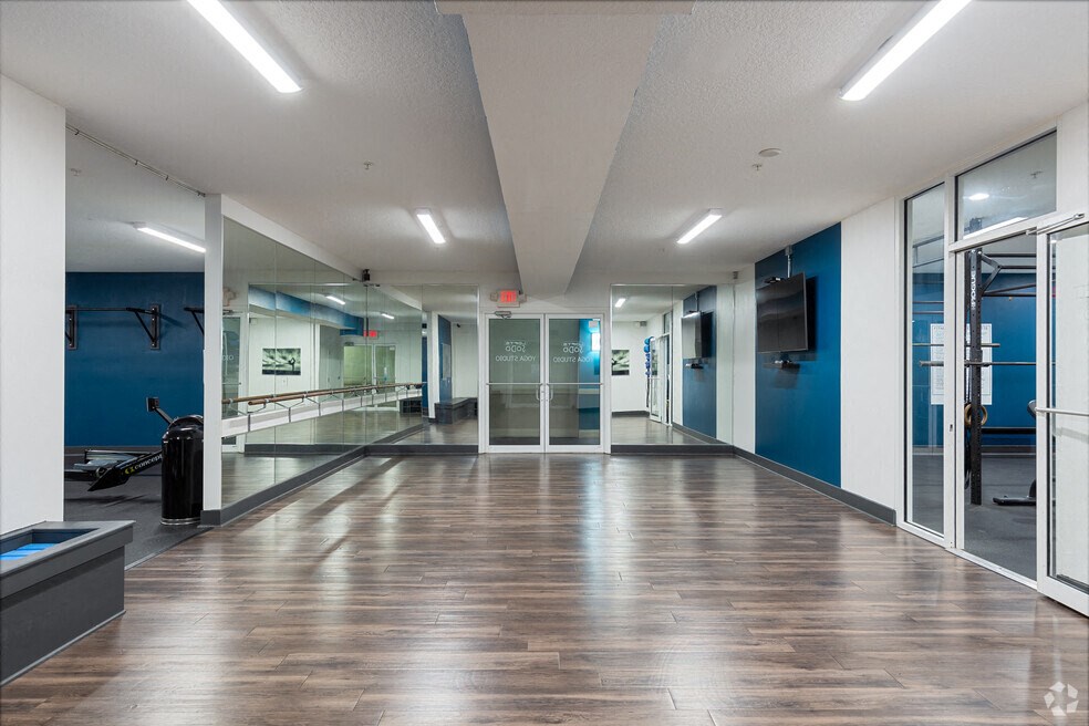 a large room with a wood floor and glass doors