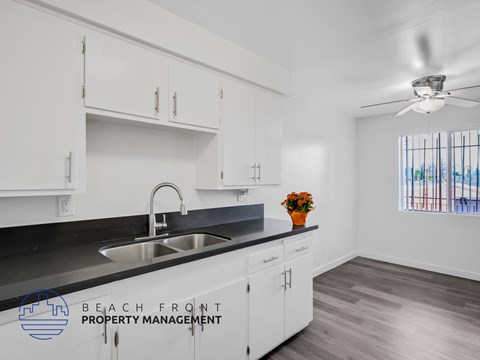 A kitchen with a sink and a window.