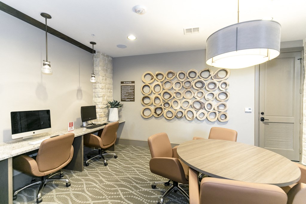 a conference room with a table and chairs and a computer