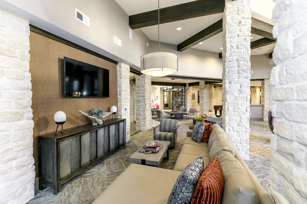 a living room with a large couch and a tv