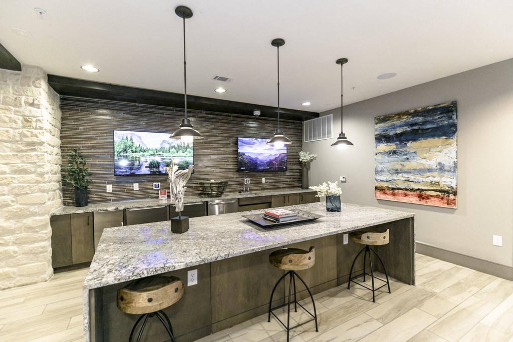a kitchen with a marble counter top and two stools