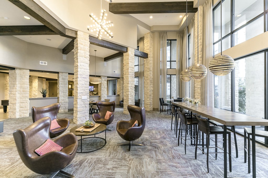 a large lobby with chairs and tables and a dining area