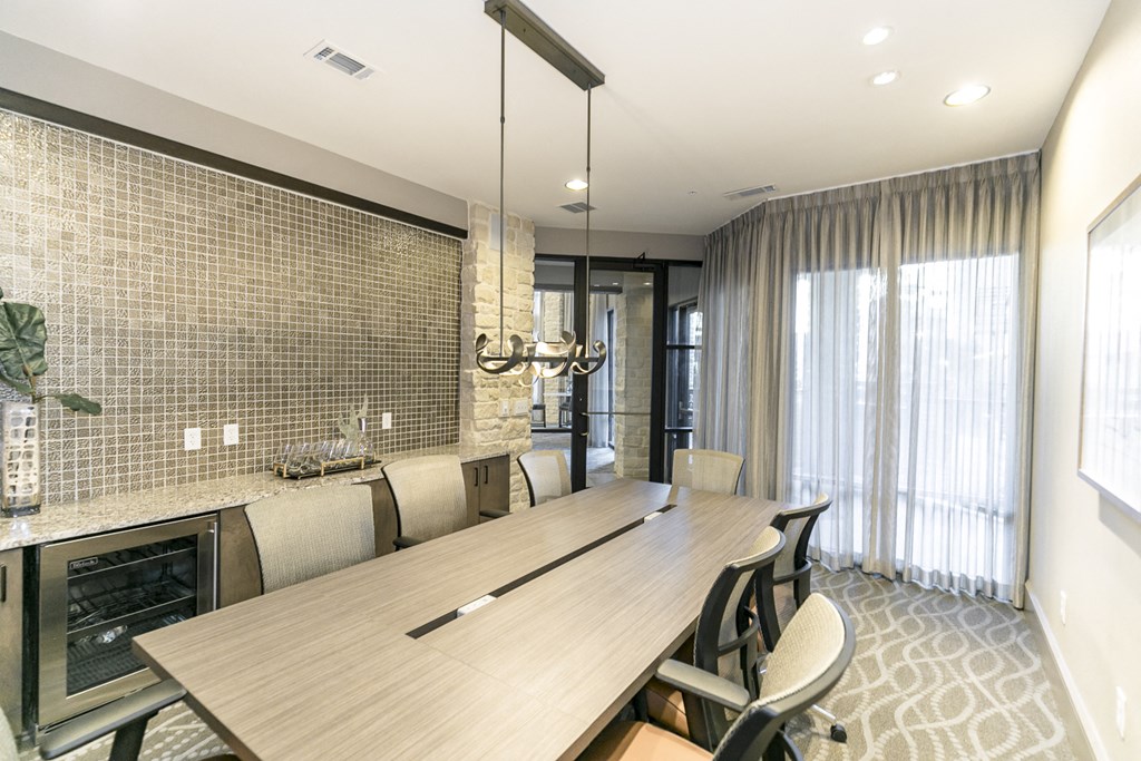 a dining room with a long wooden table and chairs