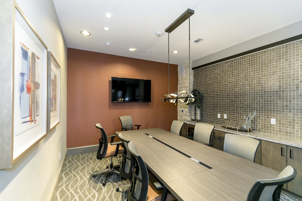 a conference room with a long wooden table and chairs