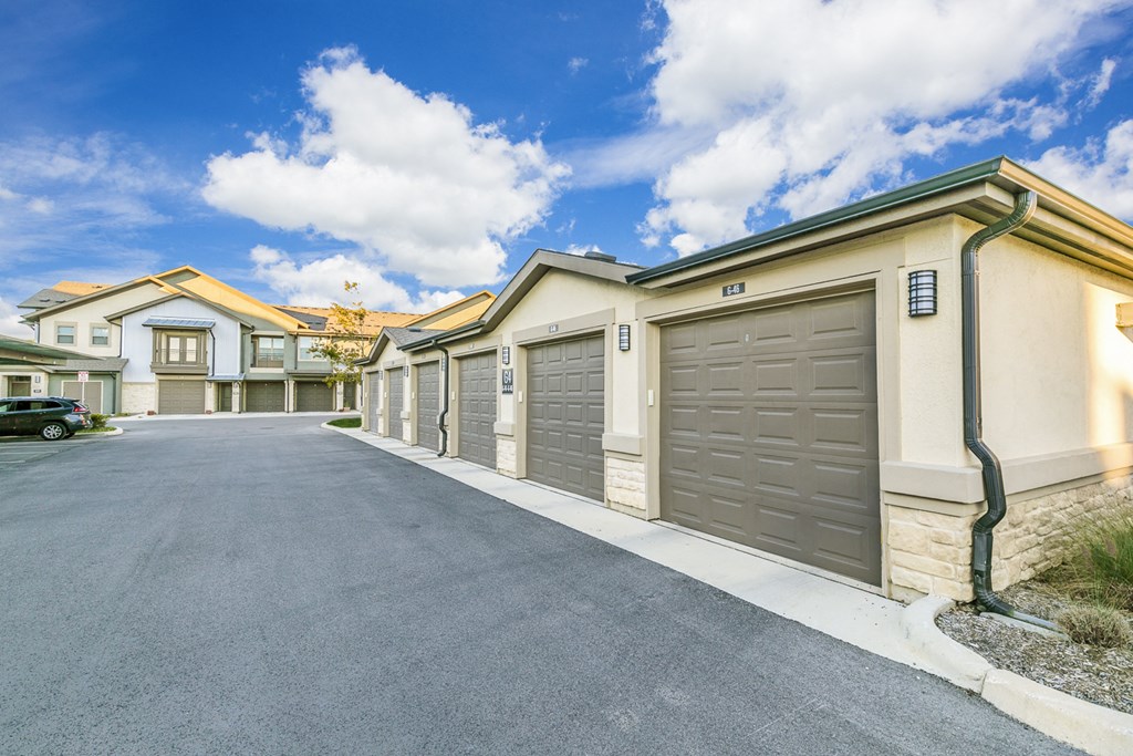 a row of garages with cars parked in front of them