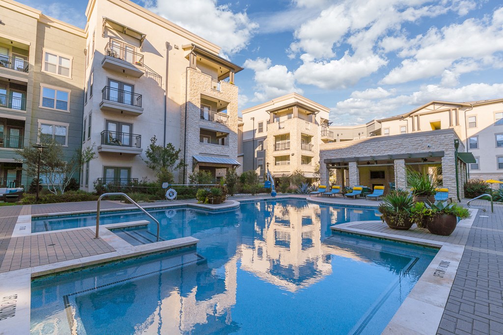 a swimming pool with buildings in the background