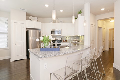 a kitchen with white cabinets and a counter top