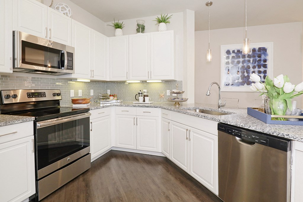 a kitchen with stainless steel appliances and white cabinets