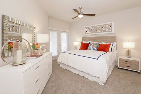 a bedroom with a bed and a ceiling fan