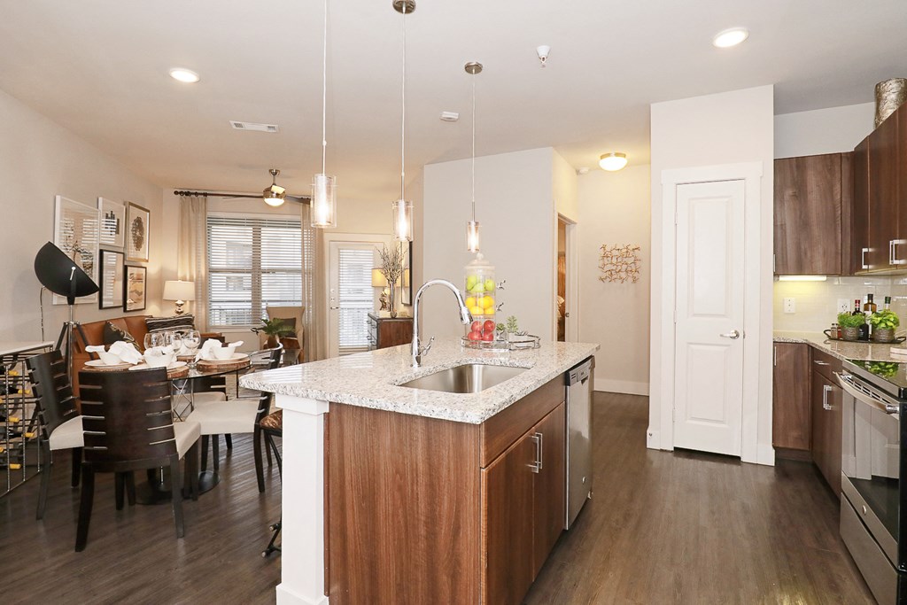 a kitchen and living room with a sink and a table