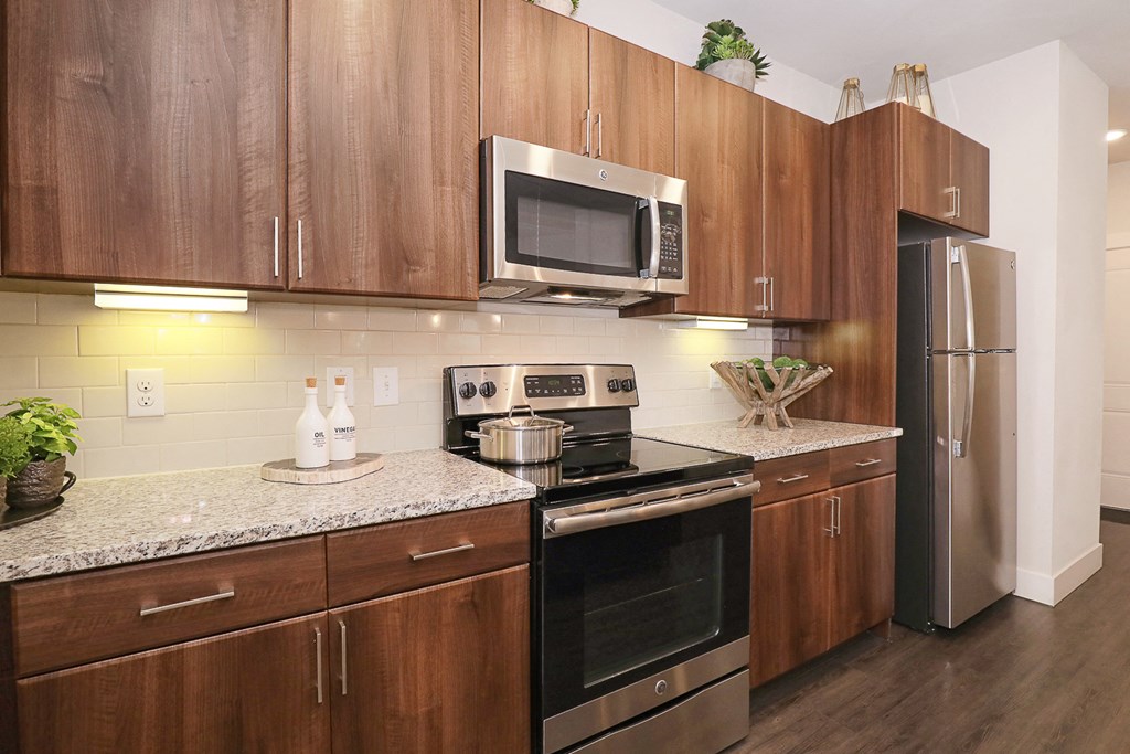 a kitchen with stainless steel appliances and granite counter tops