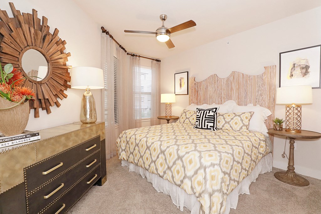 a bedroom with a large bed and a ceiling fan