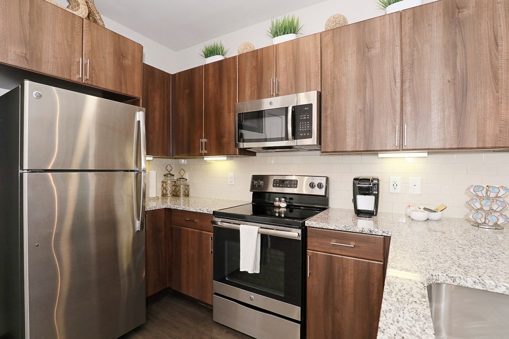 a kitchen with stainless steel appliances and granite counter tops