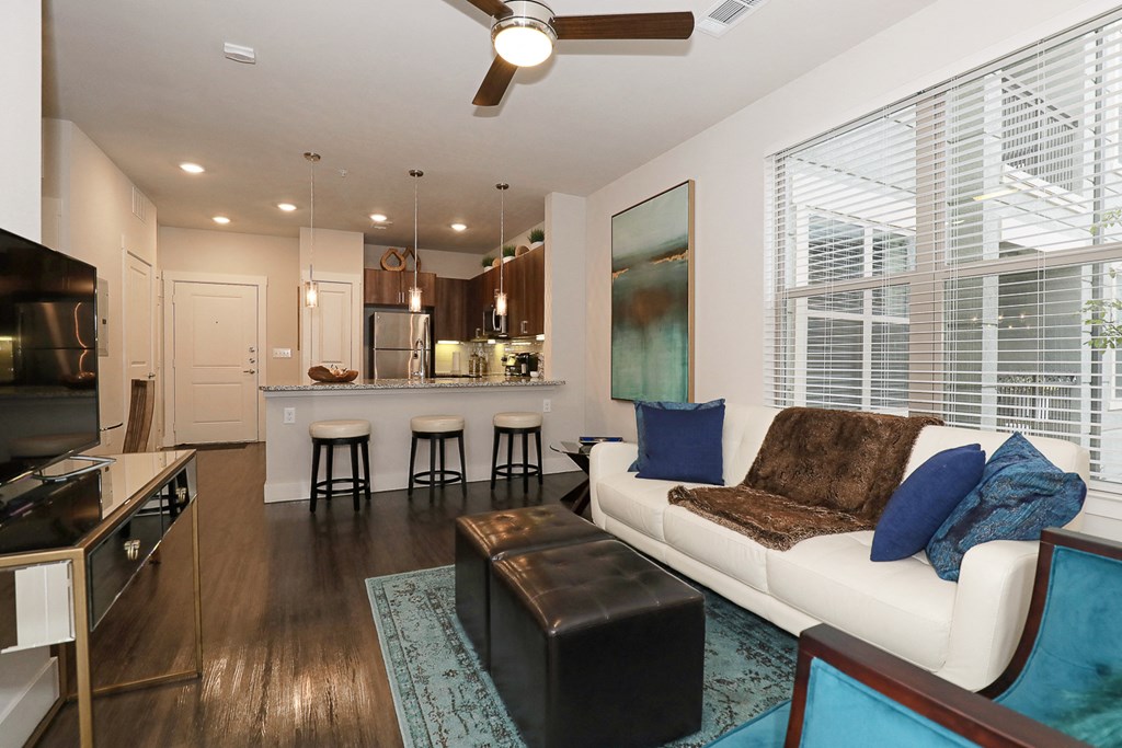 a living room and kitchen with a couch and a table