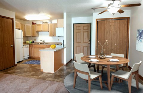 A kitchen with a table and chairs in the middle of the room.