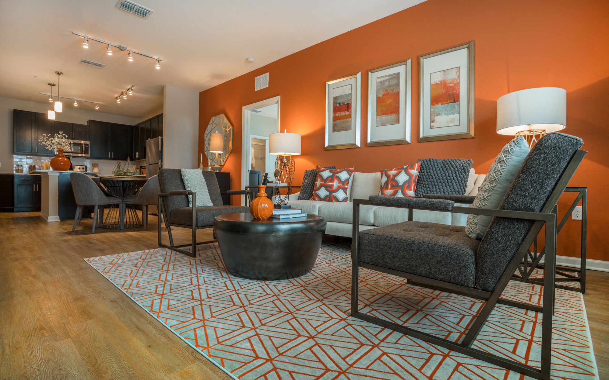 a living room with a couch and chairs