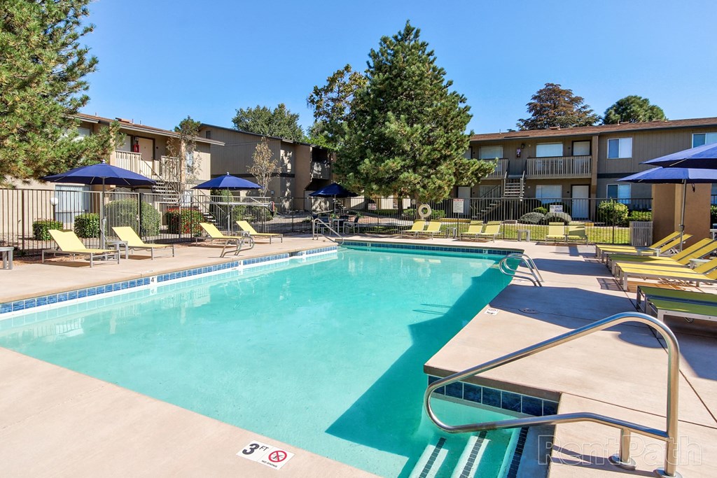 our apartments have a swimming pool with chairs and umbrellas