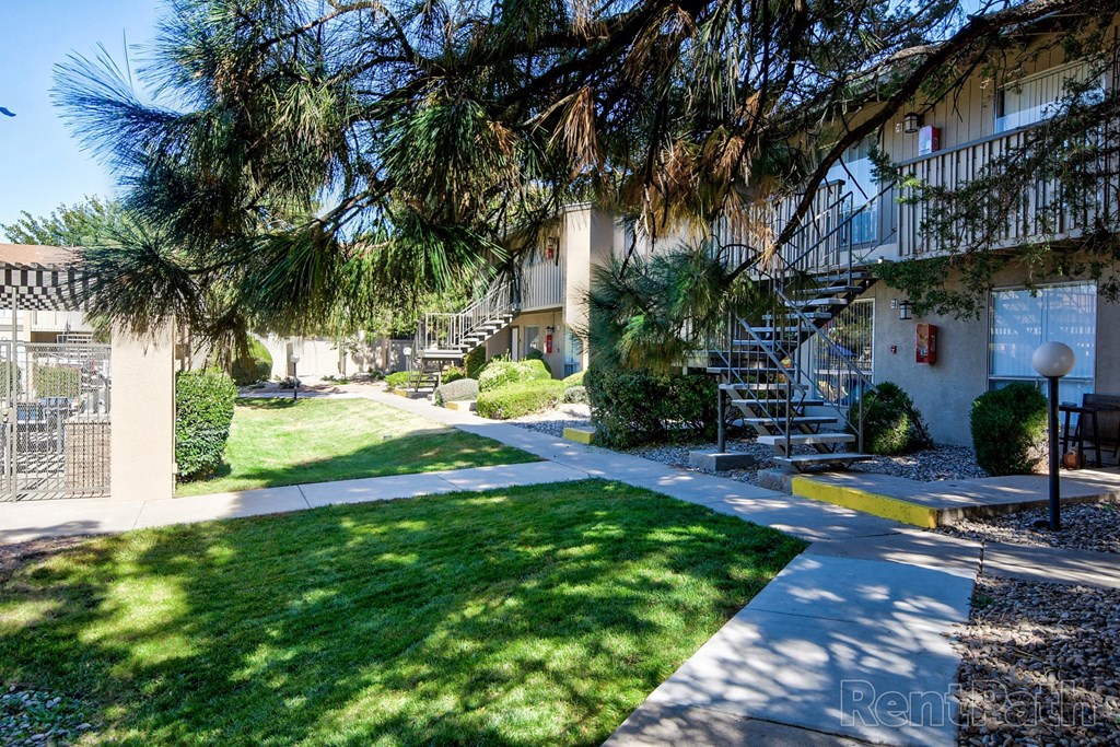 a sidewalk in front of an apartment building