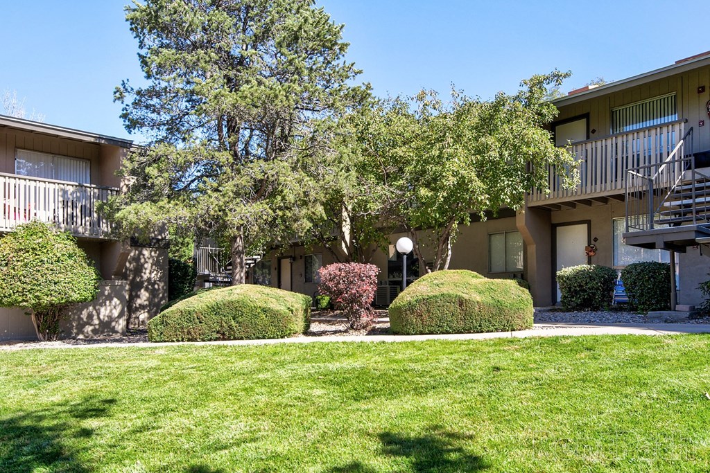 a building with a lawn and trees in front of it