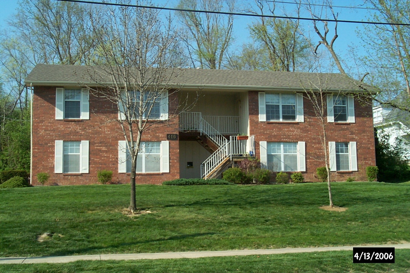 A house with a tree in front of it.