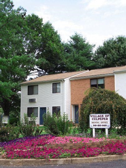 a white house with a sign in front of it