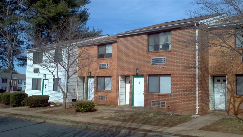 a red brick apartment building with white doors