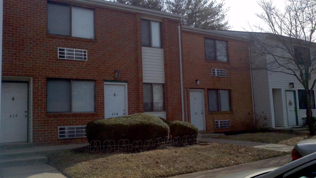 a red brick apartment building with white doors