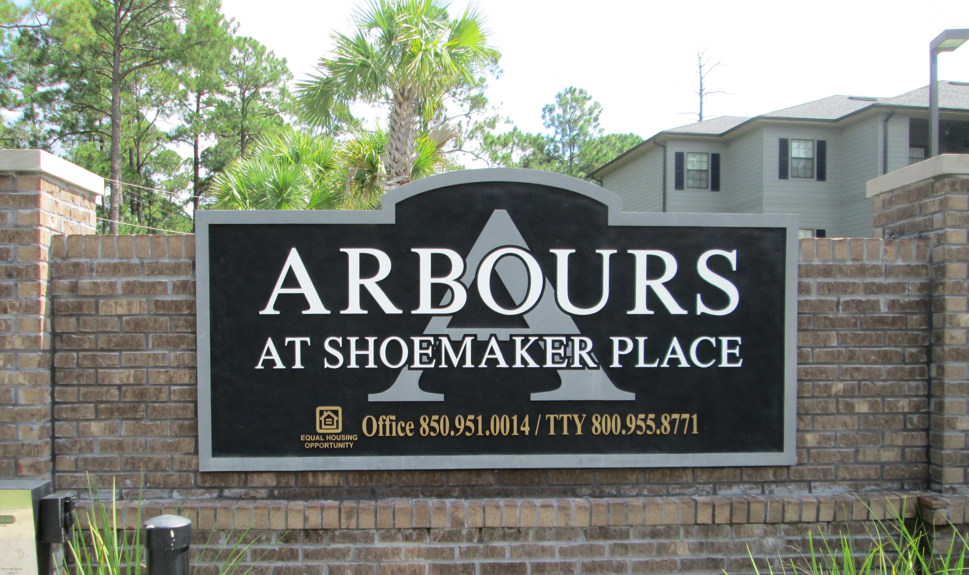 a sign that says arbours at shoemaker place in front of a house