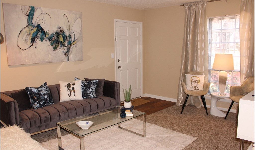 a living room with a couch and a glass table