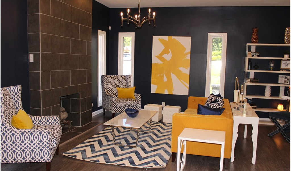a living room with blue and yellow furniture and a fireplace