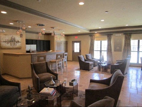 a large living room with chairs and a bar