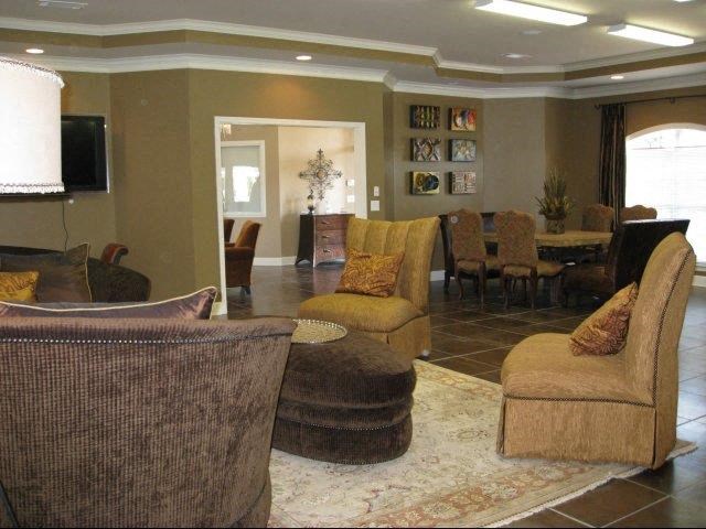 a living room with couches and chairs and a table