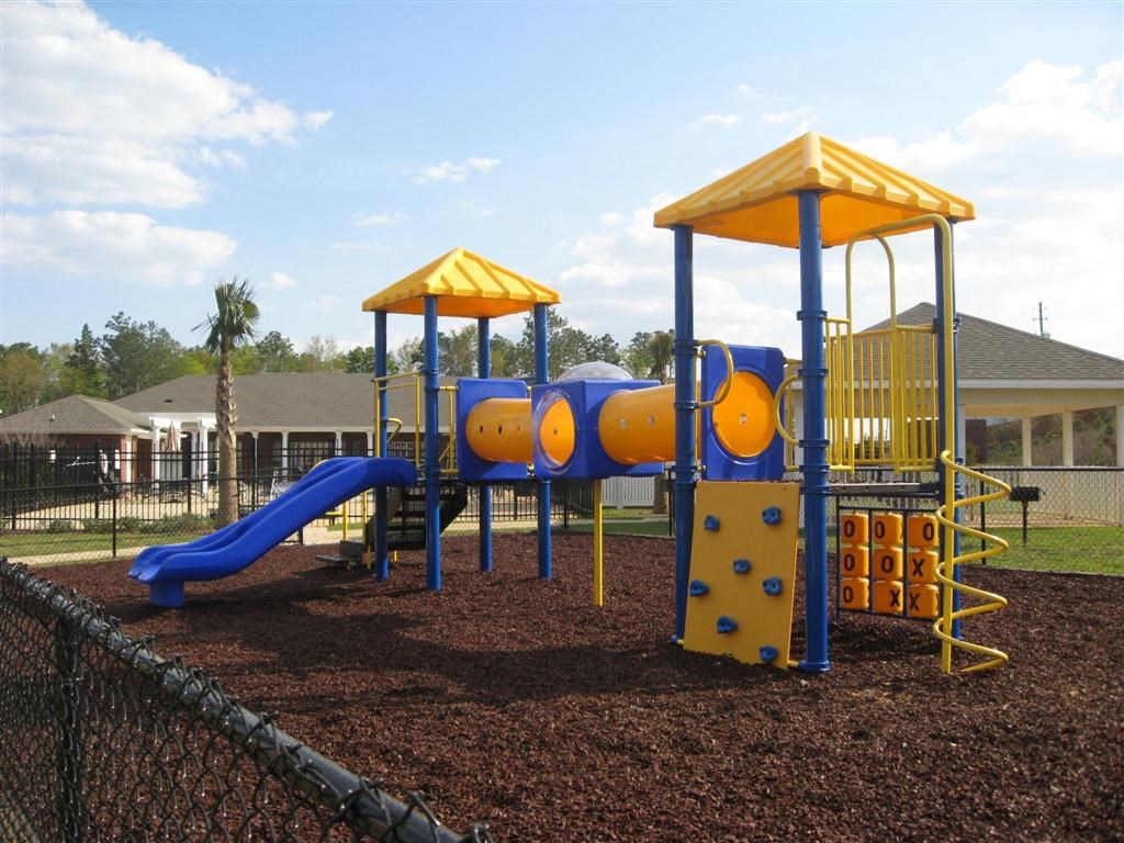 a playground with a blue and yellow play set
