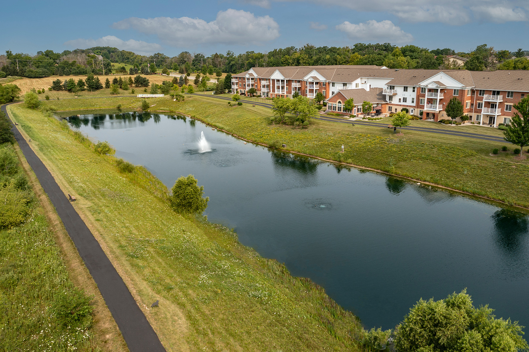 an aerial view of a river with houses in the background
