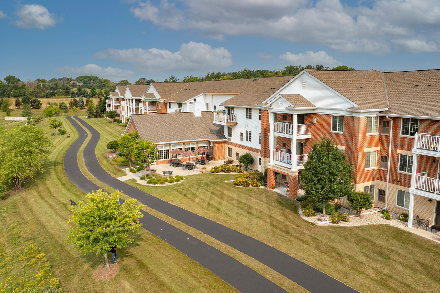 an aerial view of a row of apartment buildings on a road
