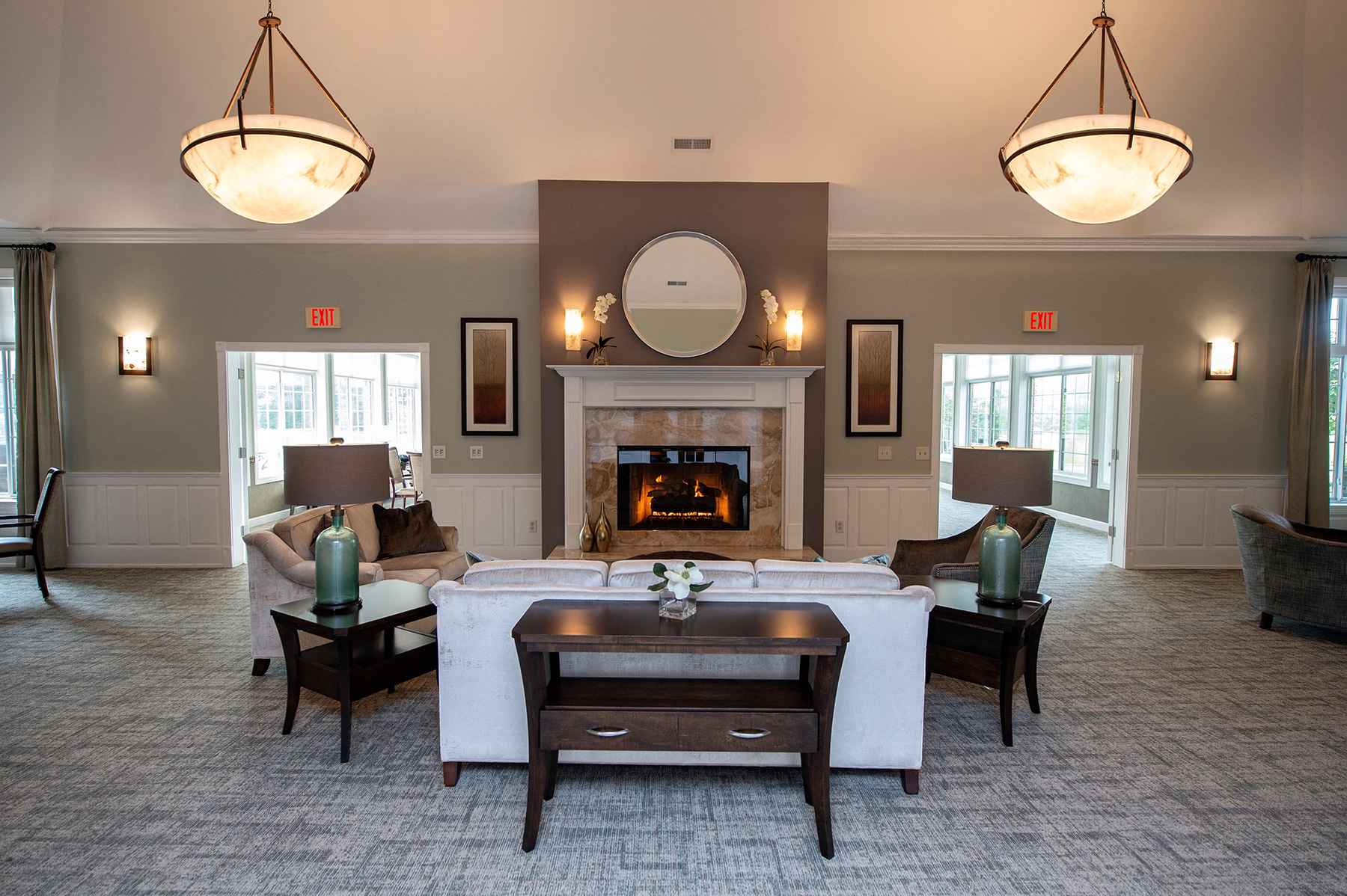 a large living room with a fireplace and a table