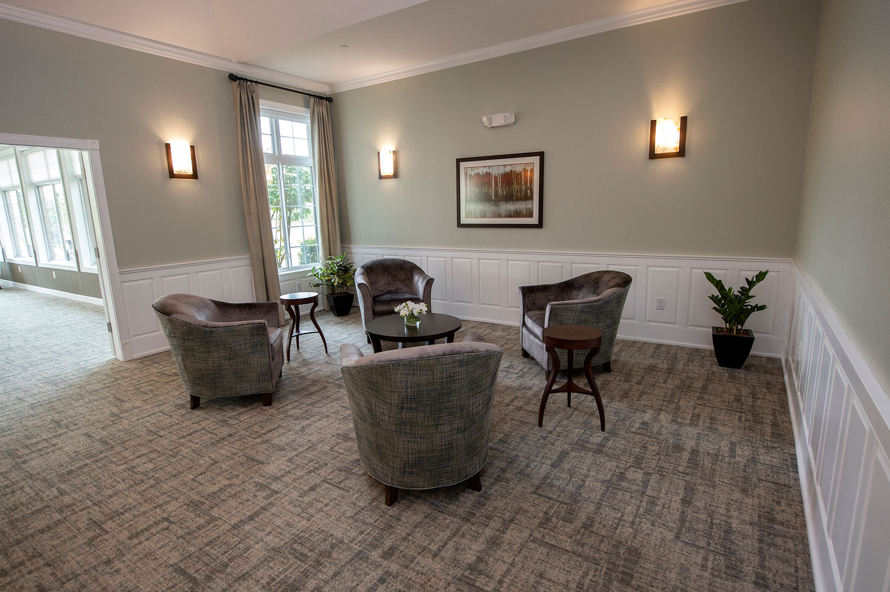 a living room with couches and chairs and a window