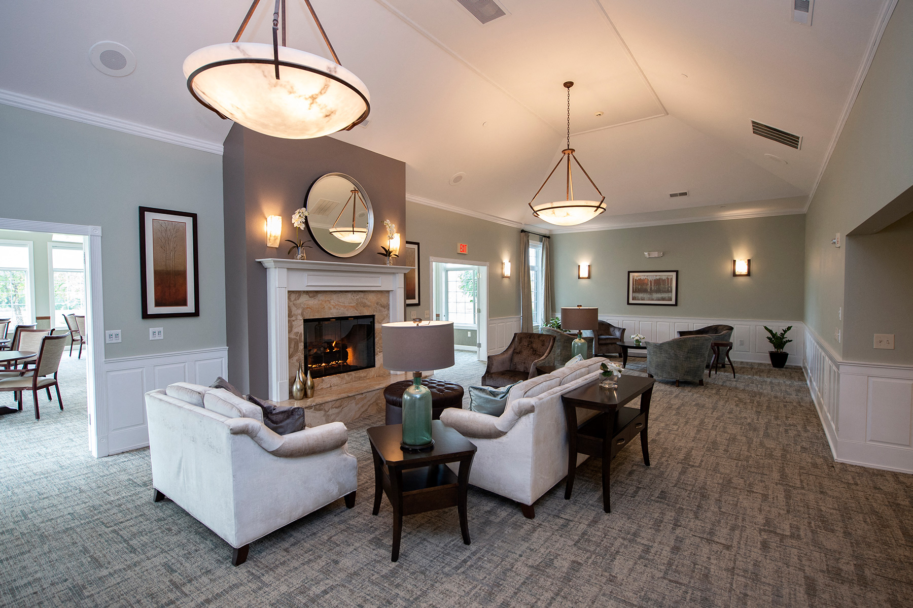a living room with couches and chairs and a fireplace