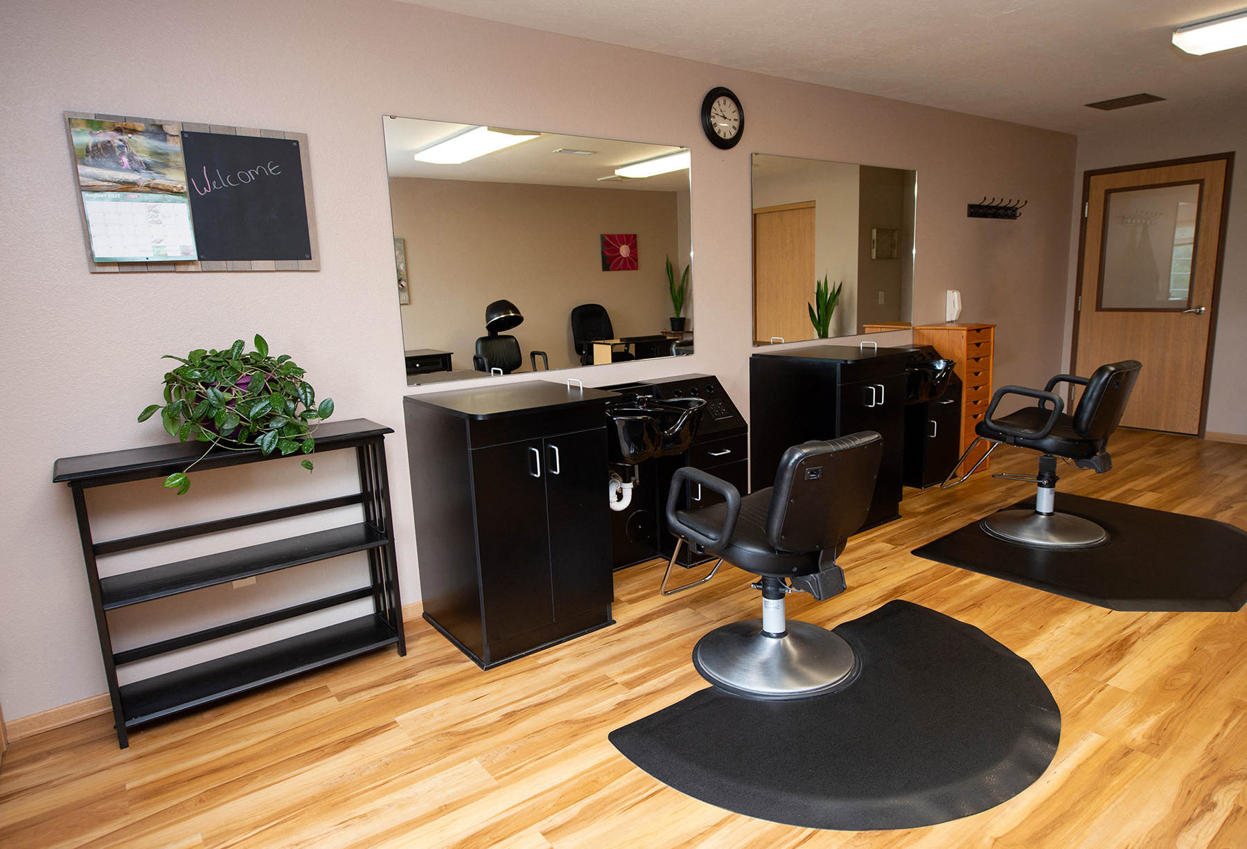 an office with wooden floors and chairs and a desk