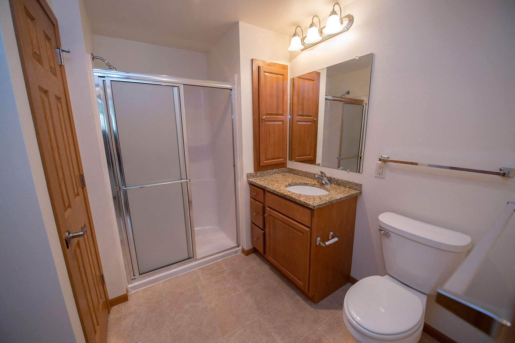 a bathroom with a toilet sink and shower